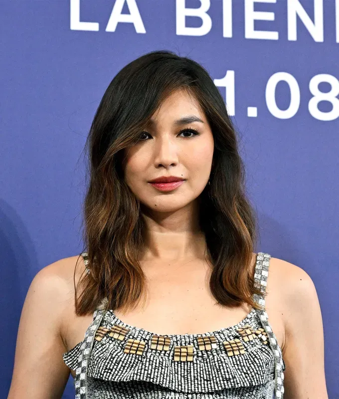 haircuts for oval faces: gemma chan wears a below-the-shoulder cut with loose waves' fetchpriority='auto' title='The 36 Most Flattering Haircuts & Hair Styles for Oval Faces