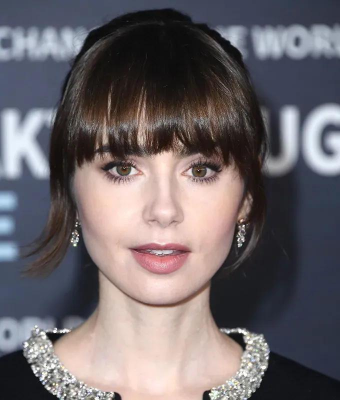 birkin bangs hair trend a photo of lily collins' fetchpriority='auto' title='Birkin Bangs Are the French-Girl Hair Trend You’ll Want to Try This Summer