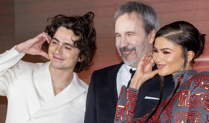 Millennial vs Gen Z Hand Heart Pose The Cheek Heart 2: a photo of Timothée Chalamet Denis Villeneuve and Zendaya Coleman' fetchpriority='auto' title='Yes Gen Z Is Even Embarrassed by the Way Millennials do a Heart Pose in Photos