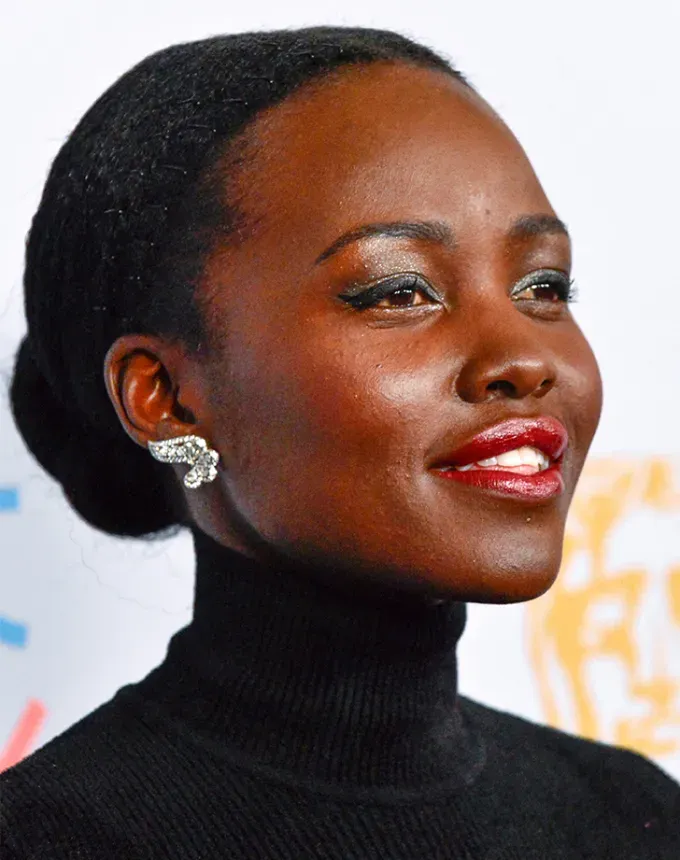 natural hairstyles for black women lupita nyongo with a low bun' fetchpriority='auto' title='55 Natural Hairstyles for Black Women—from Casual to *Very* Special Occasion