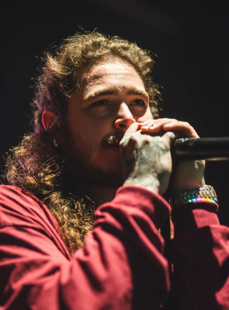 Post Malone making music as part of his net worth' title='Post Malone’s Net Worth & How He Spends His Money' typeof='foaf:Image' decoding='async