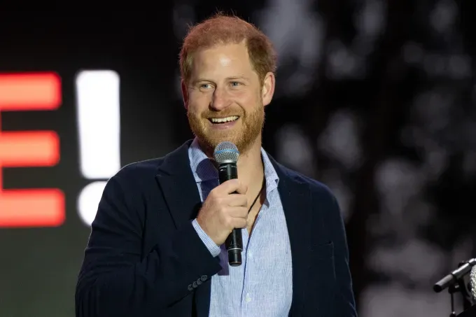 prince harry holds mic' fetchpriority='auto' title='Prince Harry Takes Stage at Concert—But I Can’t Get Over What’s Around His Neck (and Its Connection to William)