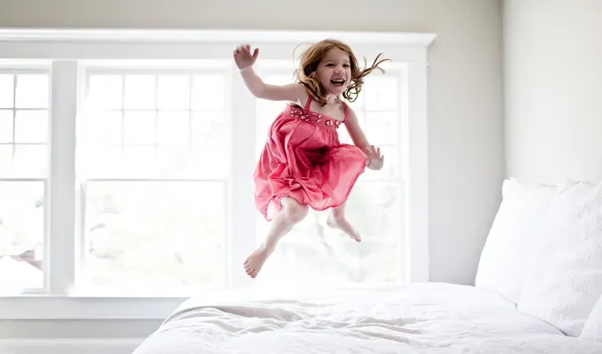 baby-names-that-mean-warrior: a young girl jumping on a bed' fetchpriority='auto' title='75 Names That Mean Warrior for a Kid Who Comes Out Kicking