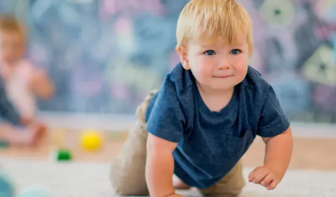 baby-names-that-mean-warrior: a baby boy crawling' fetchpriority='auto' title='75 Names That Mean Warrior for a Kid Who Comes Out Kicking