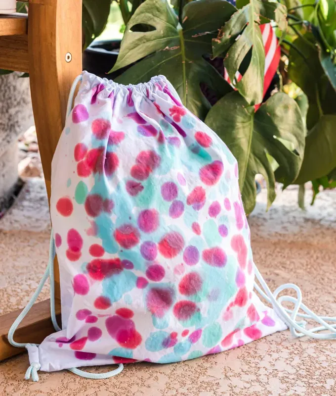a drawstring backpack covered in tie dye' fetchpriority='auto' title='40 Back-to-School Crafts for Kids to Combat First Day Butterflies