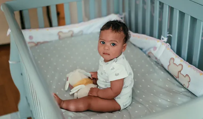 uncommon-baby-names-little-girl-in-crib' fetchpriority='auto' title='150 Uncommon Baby Names to Help Your Child Stand Out from the Crowd