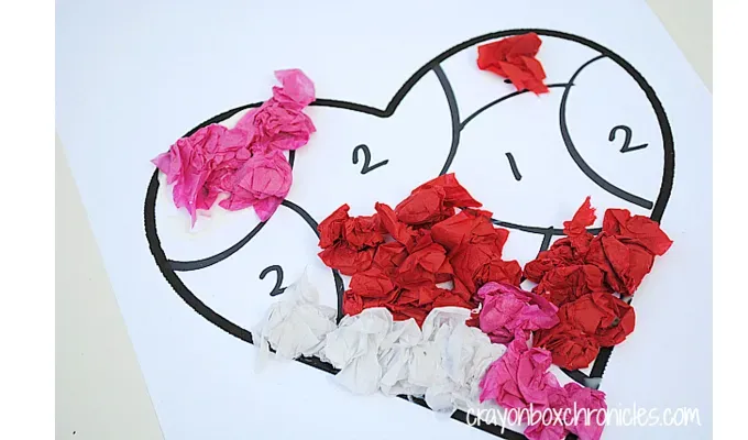 valentines-crafts-for-kids: A tissue paper by number craft in the shape of a heart in progress.' title='70 Fun and Easy Valentine’s Day Crafts for Kids