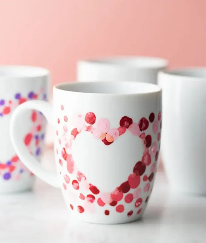 a white mug with painted heart.' title='70 Fun and Easy Valentine’s Day Crafts for Kids