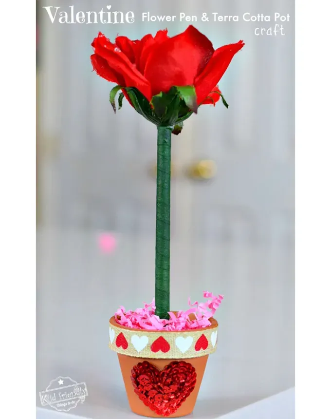52 Fun and Easy Valentine’s Day Crafts for Kids - A pen disguised as a rose with red petals and a green stem is planted in a decorative terracotta pot.' title='70 Fun and Easy Valentine’s Day Crafts for Kids