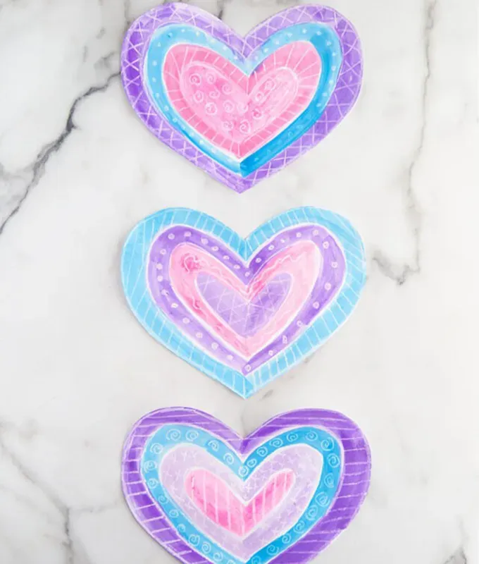 paper hearts colored with crayon.' title='70 Fun and Easy Valentine’s Day Crafts for Kids