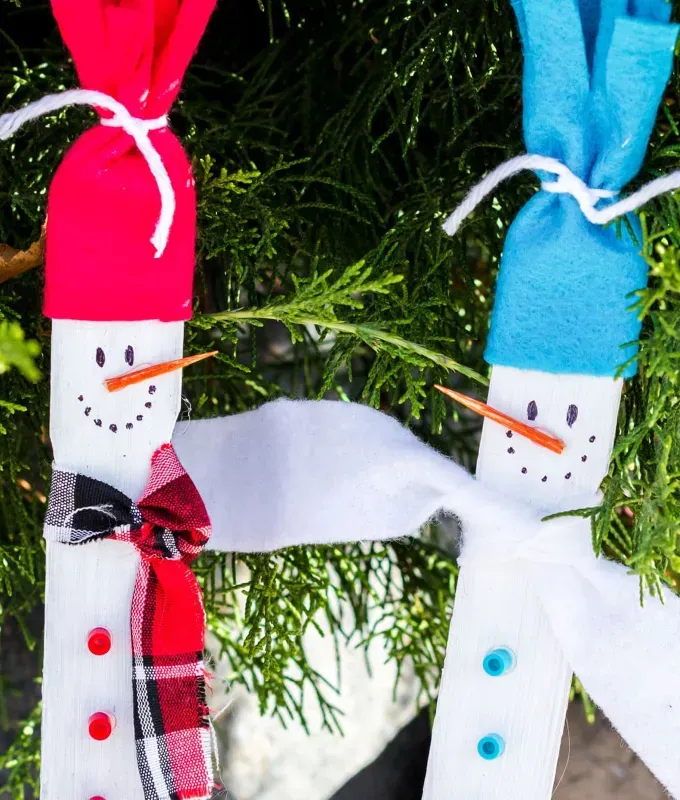 Paint stick snowmen are a great Christmas craft idea for toddlers' title='35 Christmas Crafts for Toddlers That They Can Actually Do