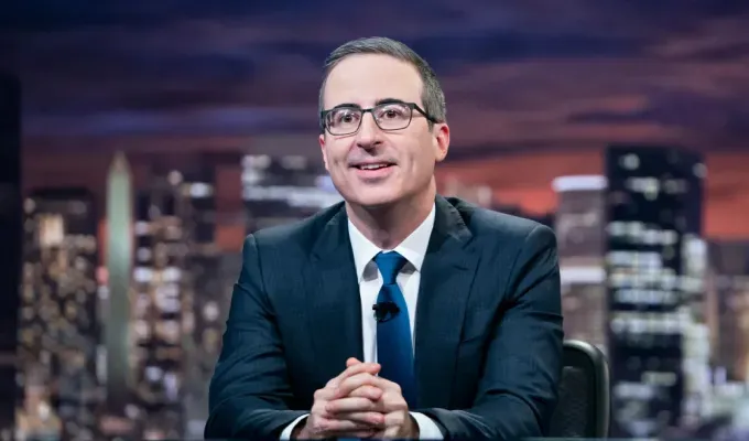 Gen X characteristics: John Oliver on television' fetchpriority='auto' title='11 Gen X Traits You’ll Totally Recognize If You Grew Up With No Internet and No One Checking On You