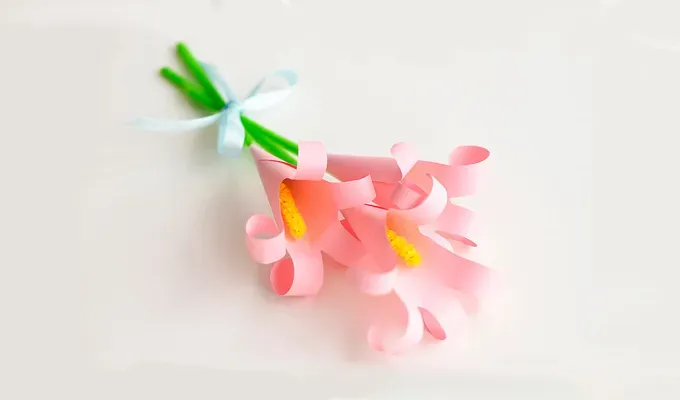 mothers-day-crafts: Pink paper flowers on a white surface.' title='45 Mother’s Day Crafts for Kids That She’ll Actually Want to Keep