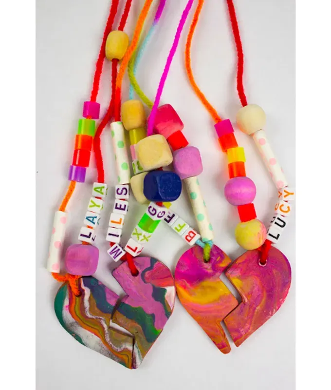 mothers-day-crafts: Colorful swirled clay necklace pendents on string adorned with funky beads.' title='45 Mother’s Day Crafts for Kids That She’ll Actually Want to Keep