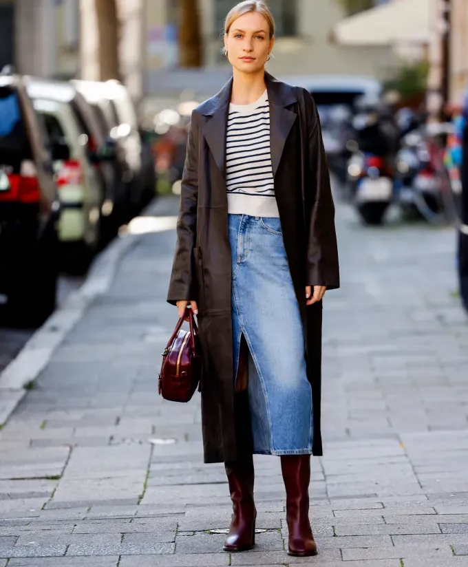 A woman wearing a denim maxi skirt with burgundy knee high boots' fetchpriority='auto' title='6 Shoes to Wear with Denim Maxi Skirts to Impress All Your Fashion Friends