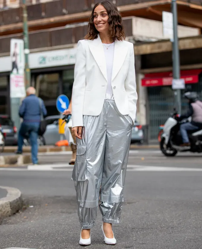 a woman wearing silver pants with a white t shirt' fetchpriority='auto' title='I’m a Veteran Fashion Editor and These Are the Best Styling Tips I’ve Learned On the Job