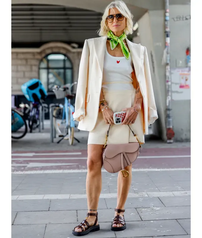 woman wearing a white skirt suit with sport sandals' fetchpriority='auto' title='I’m a Fashion Editor—Here Are My 4 Rules for What Shoes to Wear with Skirts