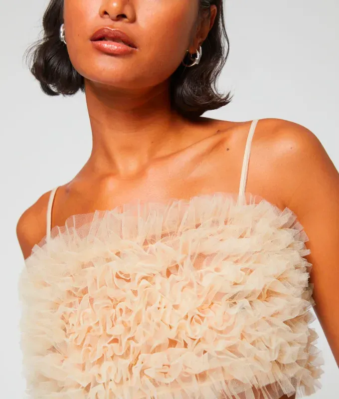 Stores Like Lulus: woman wearing a spaghetti strap tulle ruffled top from & Other Stories' title='20 Stores Like Lulus to Shop Right Now