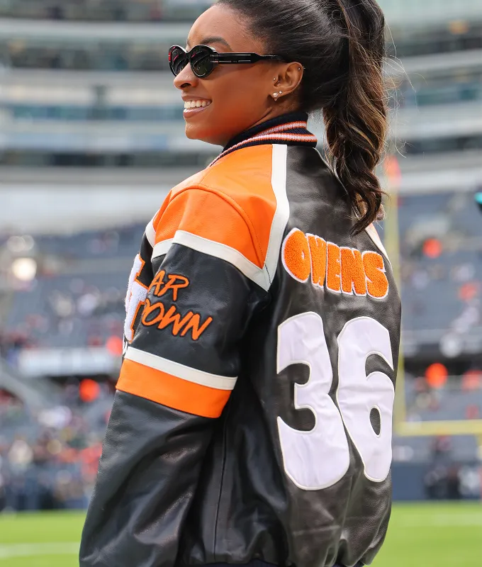 simone-biles-denim-outfit-black-and-orange-outfit' fetchpriority='auto' title='Simone Biles’s Denim Outfit and Boots Stole the Show on the NFL Sidelines
