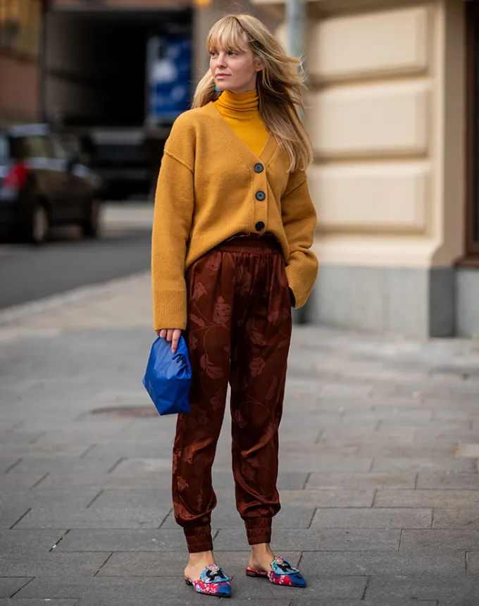 woman wearing silky pants and a cardigan' fetchpriority='auto' title='31 Outfit Ideas for a Sparkly Stylish and Rather Festive December