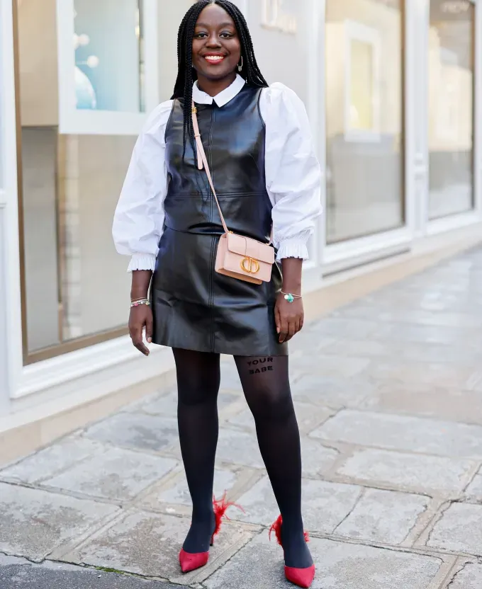 woman wearing a leather mini dress december outfit ideas 2022' fetchpriority='auto' title='31 Outfit Ideas for a Sparkly Stylish and Rather Festive December