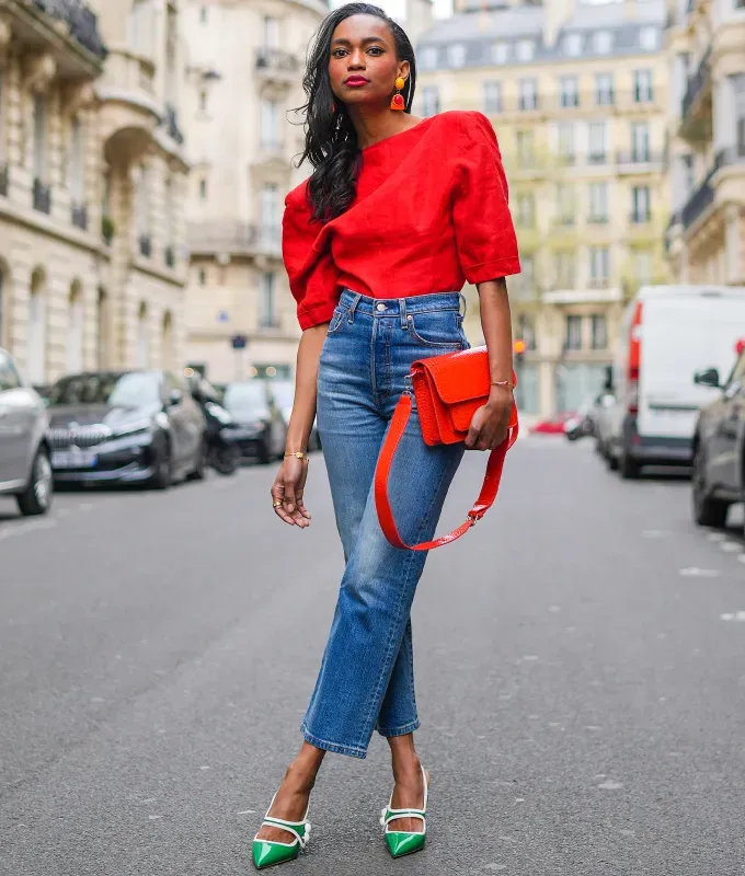 woman wearing a red top and green heels december outfit ideas 2022' fetchpriority='auto' title='31 Outfit Ideas for a Sparkly Stylish and Rather Festive December