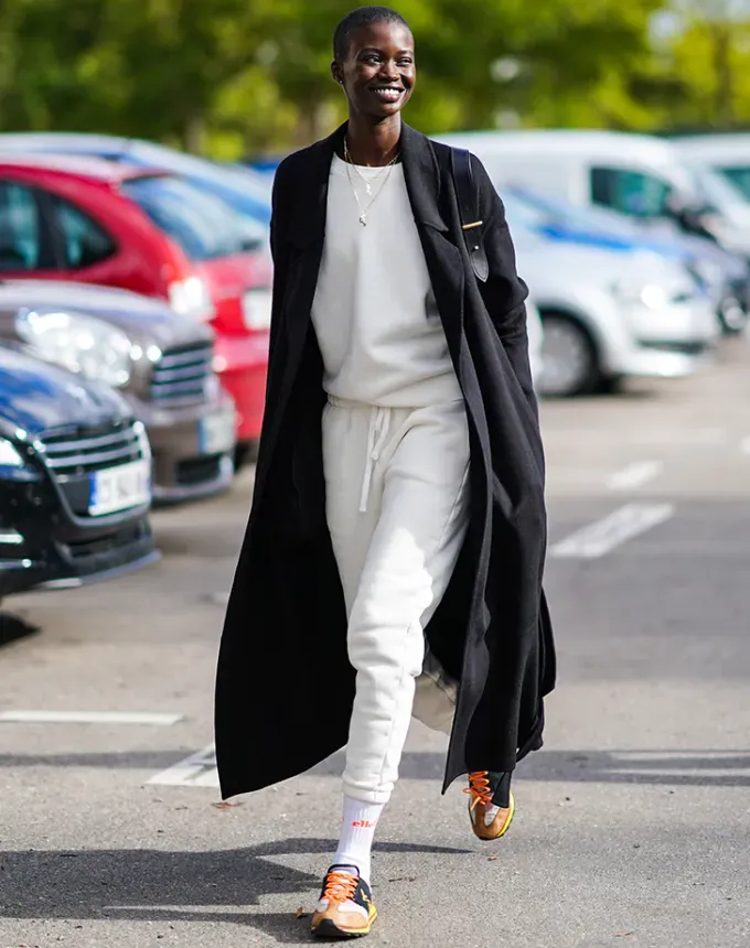 woman wearing sweats and a long coat' fetchpriority='auto' title='31 Outfit Ideas for a Sparkly Stylish and Rather Festive December