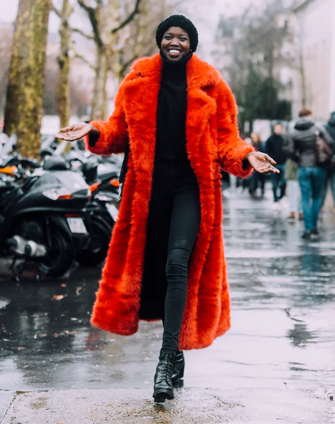 woman wearing a red faux fur coat' fetchpriority='auto' title='31 Outfit Ideas for a Sparkly Stylish and Rather Festive December