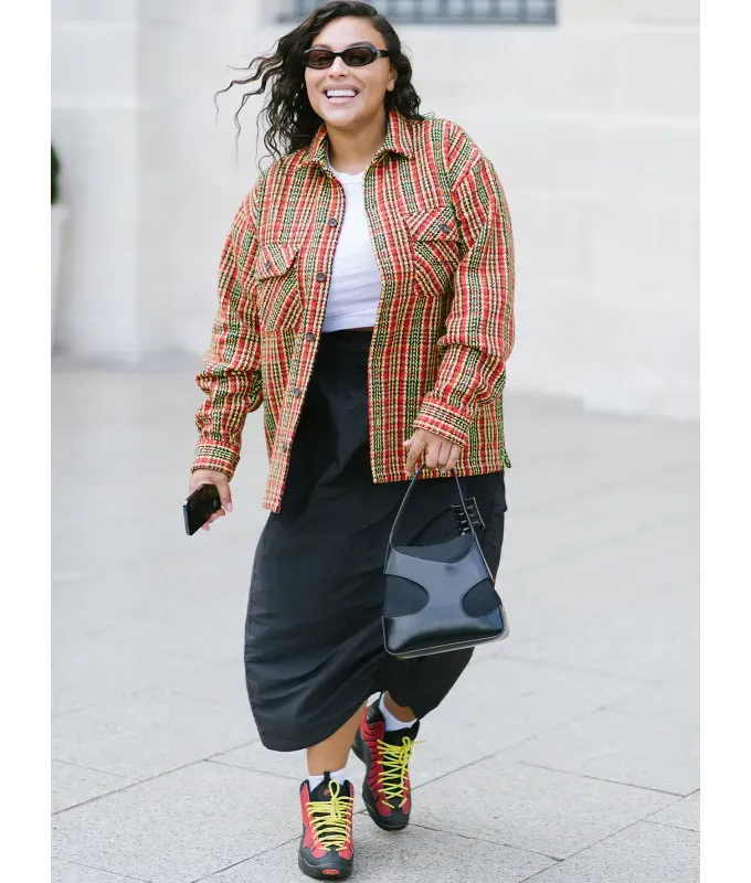 woman-wearing-a-black-slip-skirt-with-hiking-shoes-and-a-plaid-jacket' fetchpriority='auto' title='22 Easy Black Skirt Outfit Ideas for When You Have Five Minutes to Get Dressed