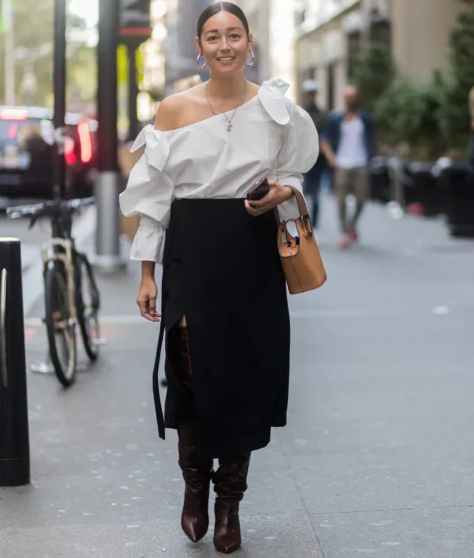 woman wearing a black midi skirt and white blouse' fetchpriority='auto' title='22 Easy Black Skirt Outfit Ideas for When You Have Five Minutes to Get Dressed