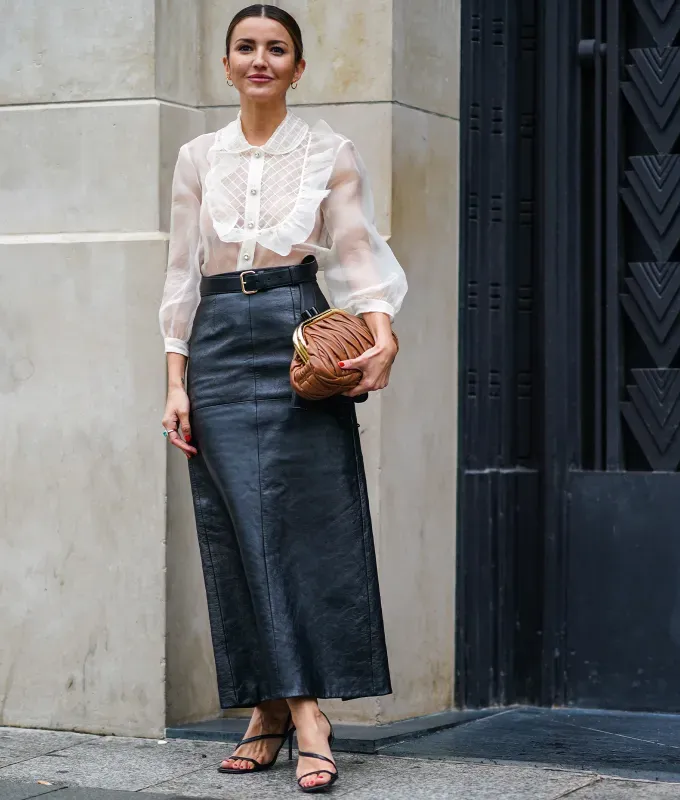woman wearing a black maxi skirt and sheer top' fetchpriority='auto' title='22 Easy Black Skirt Outfit Ideas for When You Have Five Minutes to Get Dressed