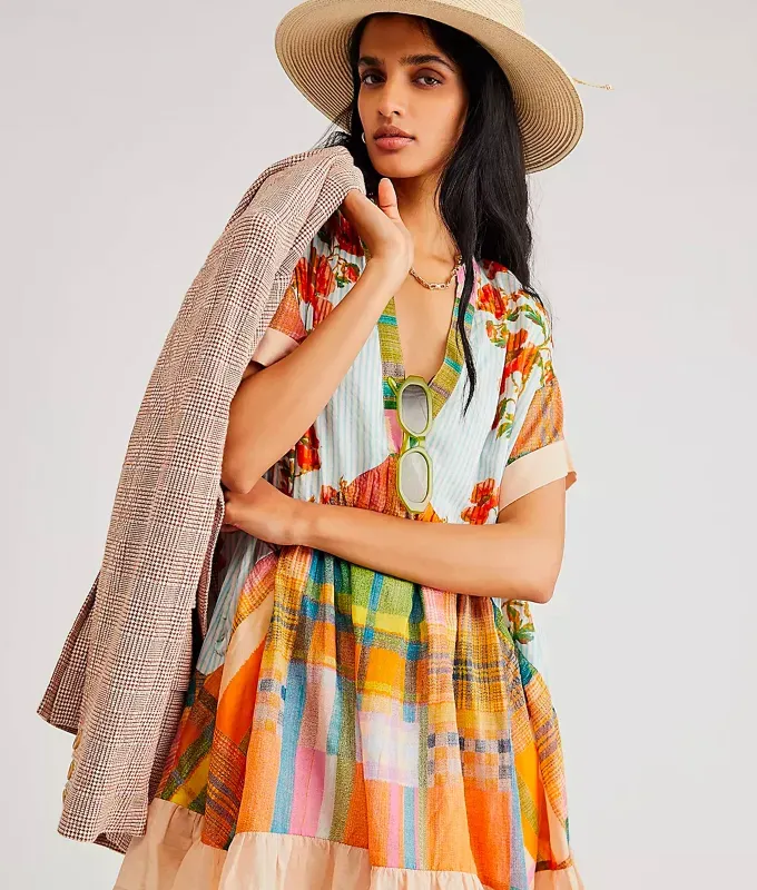 stores like hm free people. Woman wearing a fedora and colorful printed babydoll dress' title='16 Stores Like H&M to Shop Right Now