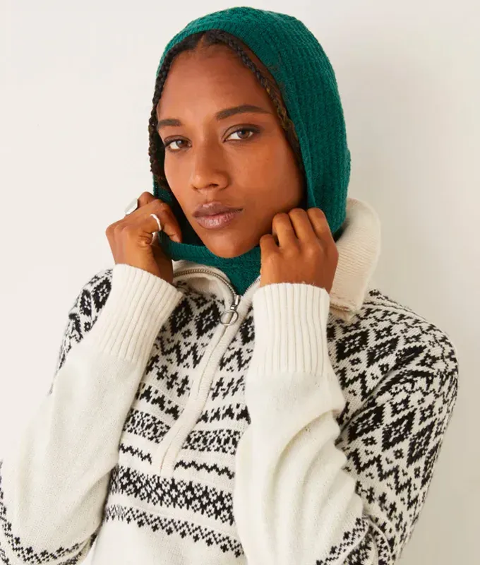 stores like hm frank oak. Woman wearing a black and white quarter zip sweater and forest green knit hood.' title='16 Stores Like H&M to Shop Right Now