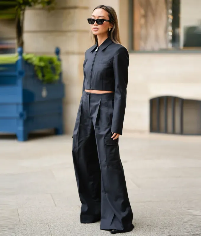Rules for Wearing Pleated Pants as a Petite: Woman in black outfit' fetchpriority='auto' title='5 Rules for Wearing Wide-Leg Pleated Pants as a Petite According to a 5’ 1 Editor and a Stylist