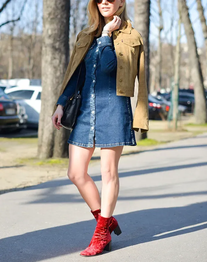 woman wearing a denim dress and red ankle boots' fetchpriority='auto' title='5 Ways to Wear a Denim Dress This Fall
