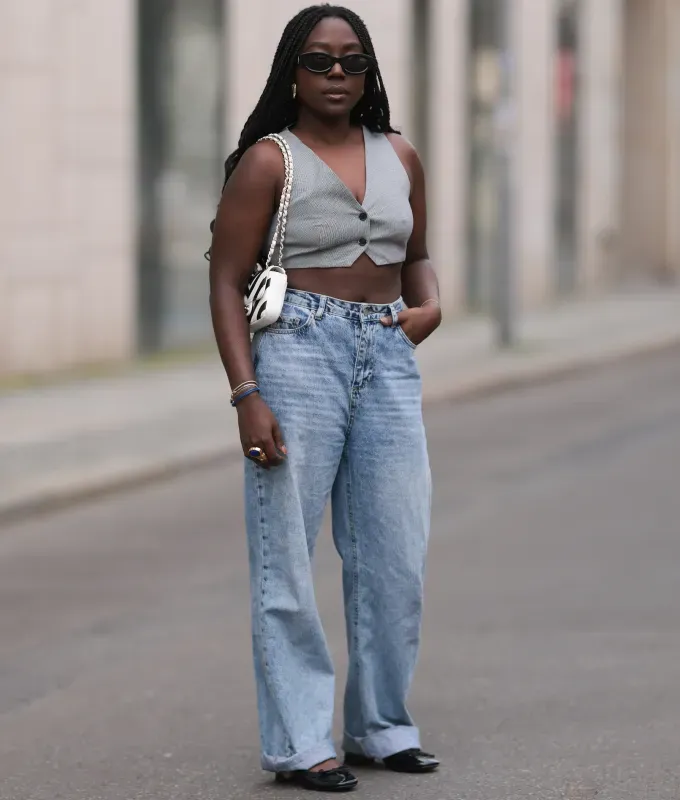 vest and straight leg jeans 90s minimalism fashion trend' fetchpriority='auto' title='The ‘90s Fashion Revival Is in Full Swing—Here’s How to Wear the Trend This Summer