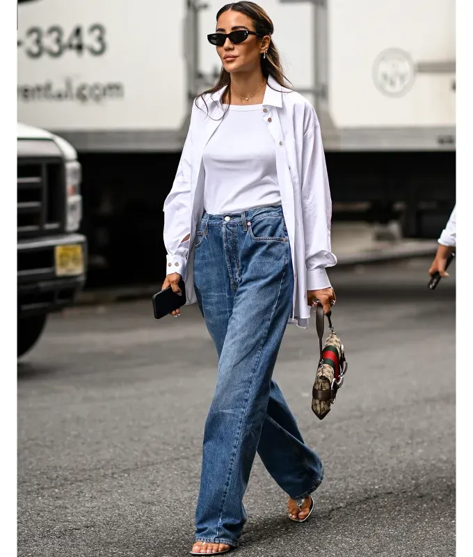 straight leg jeans and button up shirt 90s minimalism fashion trend' fetchpriority='auto' title='The ‘90s Fashion Revival Is in Full Swing—Here’s How to Wear the Trend This Summer
