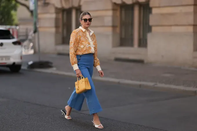 The Three-Color Rule in Fashion: Street style photo of woman wearing a yellow top yellow bag blue jeans' fetchpriority='auto' title='Is the Three-Color Rule the Secret to Looking Effortlessly Put-Together? I Put It to the Test