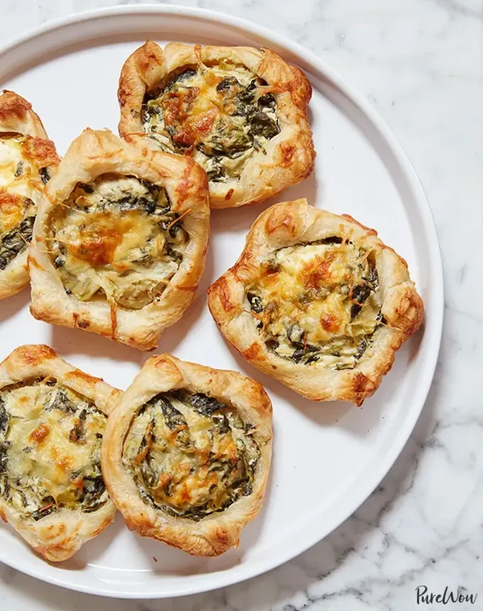 savory appetizers: spinach artichoke squares' title='51 Savory Appetizers That Are Sure to Get the Party Started from Make-Ahead Gems to Cheesy Delights