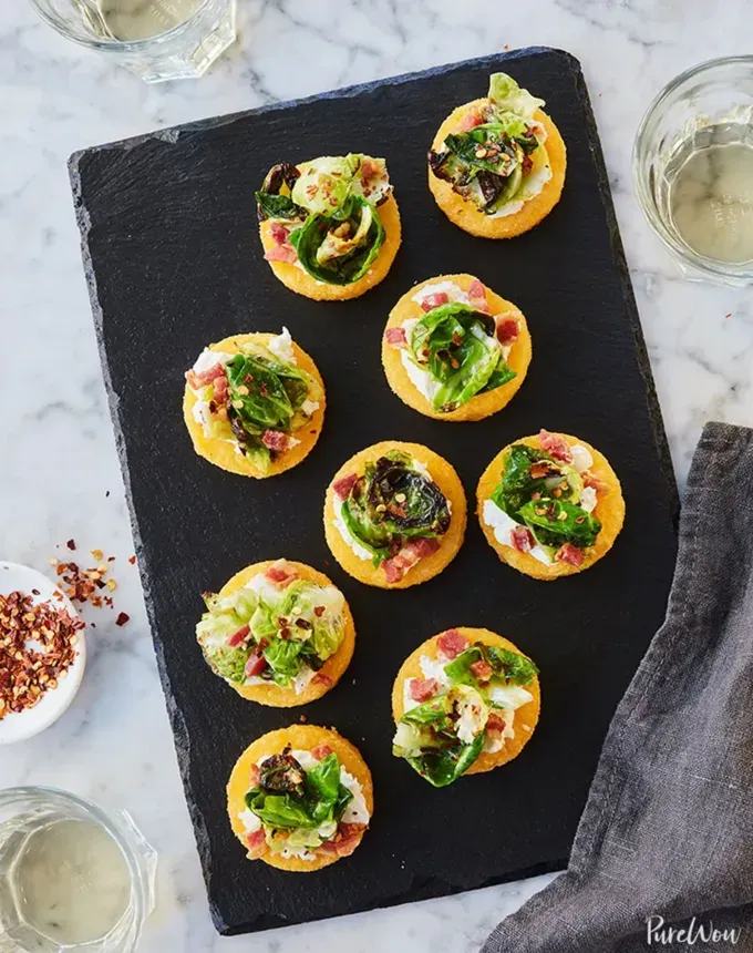 savory appetizers: cheesy polenta bites with brussels sprouts and pancetta' title='51 Savory Appetizers That Are Sure to Get the Party Started from Make-Ahead Gems to Cheesy Delights