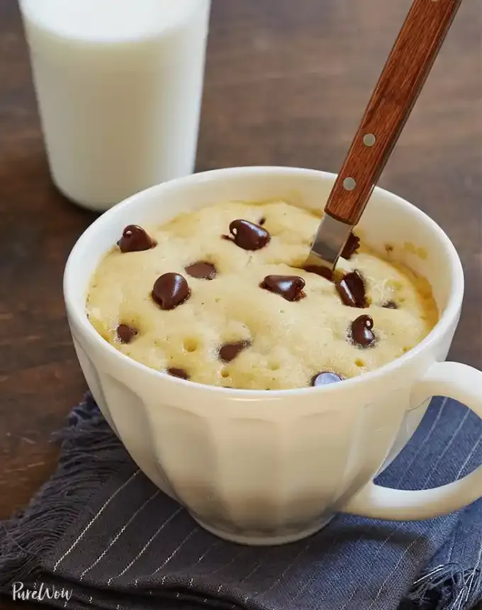fun things to bake: mug chocolate chip cookie with a spoon and a glass of milk' title='78 Easy Fun Things to Bake When You’re Bored and Craving Something Sweet