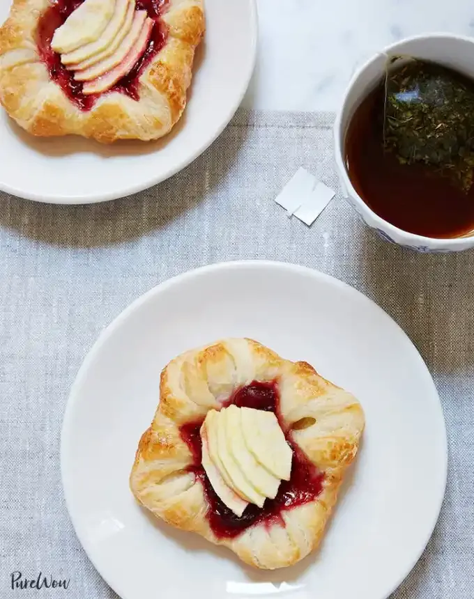 fun things to bake: aerial of two cranberry-apple danishes on plates with a cup of coffee' title='78 Easy Fun Things to Bake When You’re Bored and Craving Something Sweet