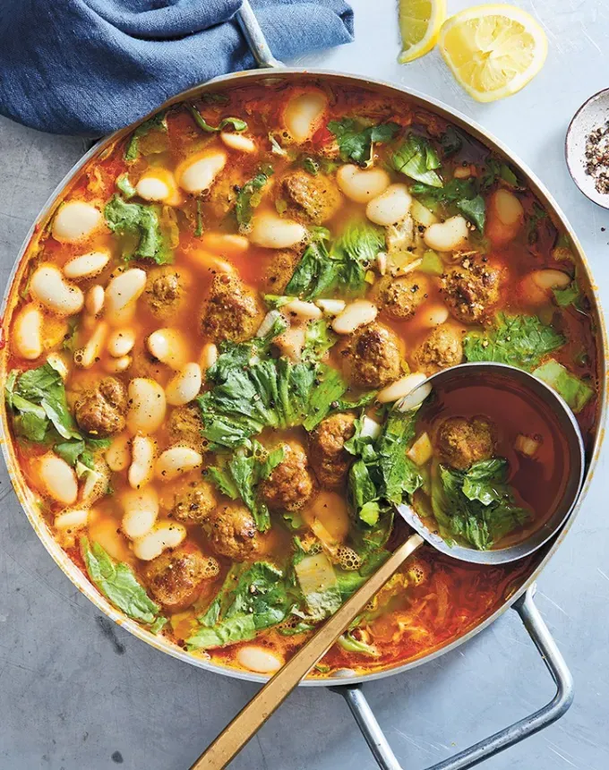 high protein soups: spiced lamb meatball and escarole soup' title='21 High-Protein Soup Recipes That Are Satisfyingly Cozy