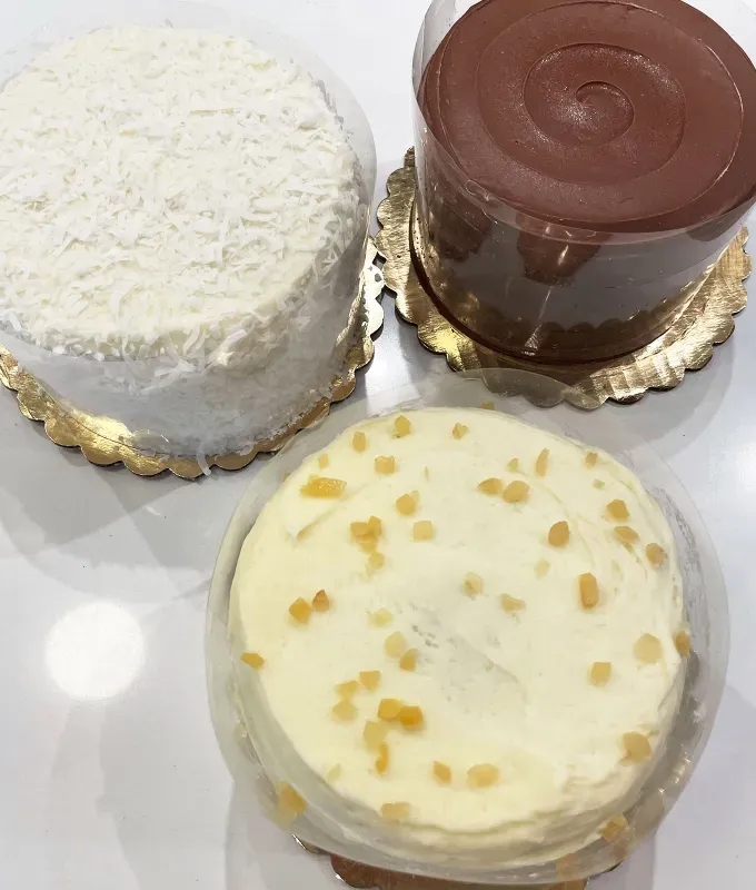 ina garten goldbelly cake review: overhead photo of ina’s coconut cake ina’s carrot cake and beatty’s chocolate cake' title='Ina Garten Sells Cake on Goldbelly—but Is It Worth the Hamptons Price Tag? I Tasted It to Find Out