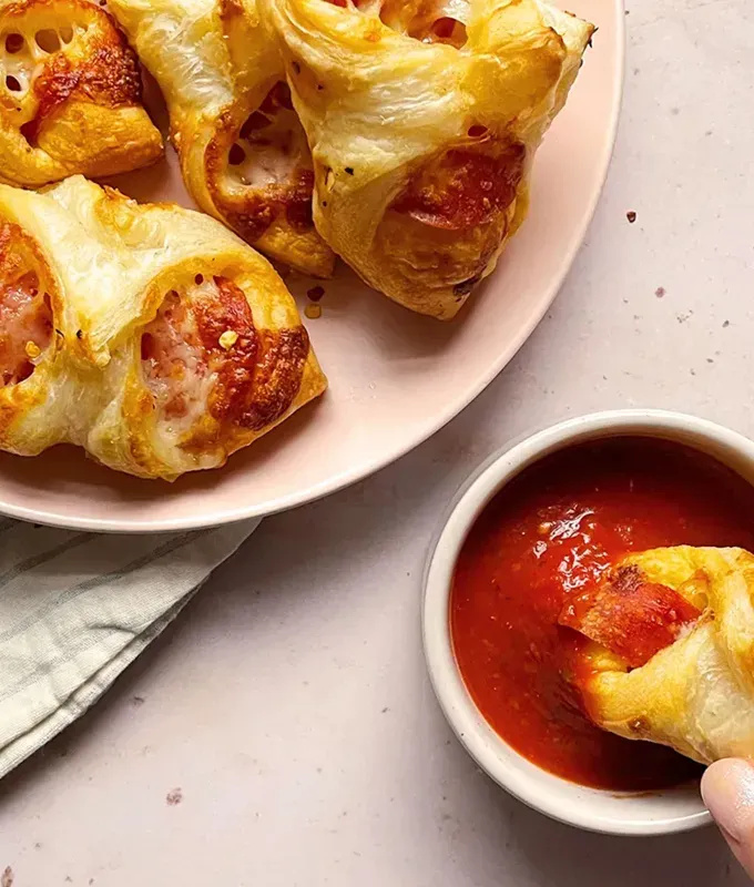 best appetizers to bring to a party: puff pastry pizza bundles' title='The 25 Best Appetizers to Bring to a Party from Crowd-Pleasing Dips to Make-Ahead Snacks