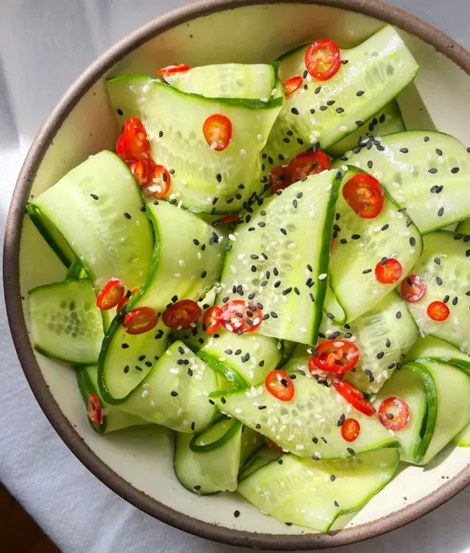 best appetizers to bring to a party: spicy crunchy sesame cucumber salad' title='The 25 Best Appetizers to Bring to a Party from Crowd-Pleasing Dips to Make-Ahead Snacks