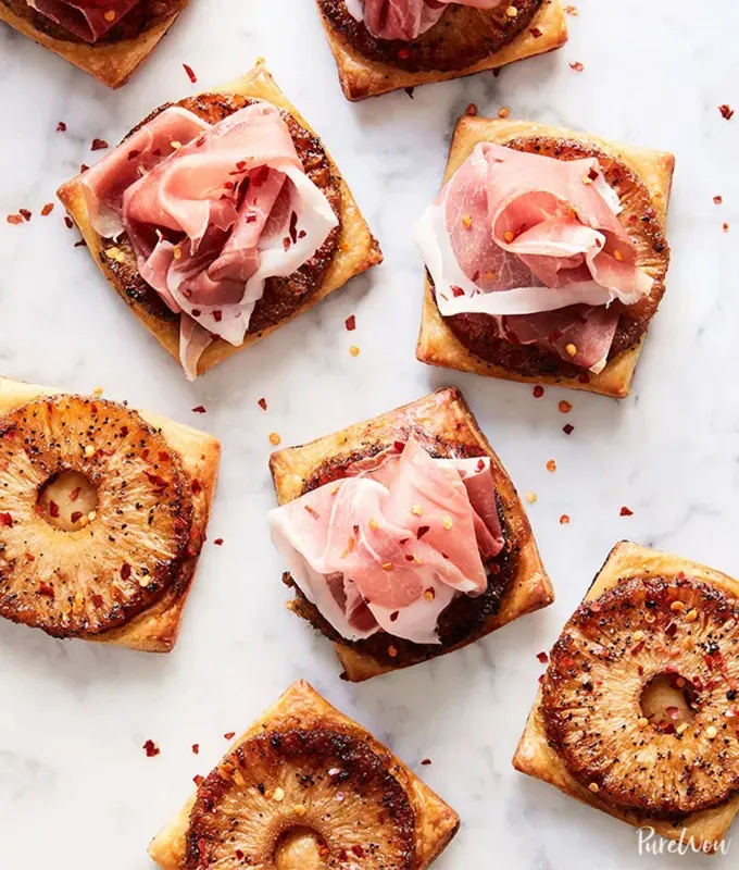 best appetizers to bring to a party: spicy pineapple prosciutto tarts' title='The 25 Best Appetizers to Bring to a Party from Crowd-Pleasing Dips to Make-Ahead Snacks