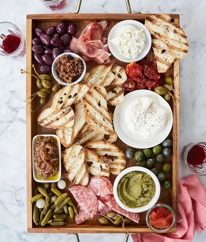 best appetizers to bring to a party: italian bruschetta bar' title='The 25 Best Appetizers to Bring to a Party from Crowd-Pleasing Dips to Make-Ahead Snacks