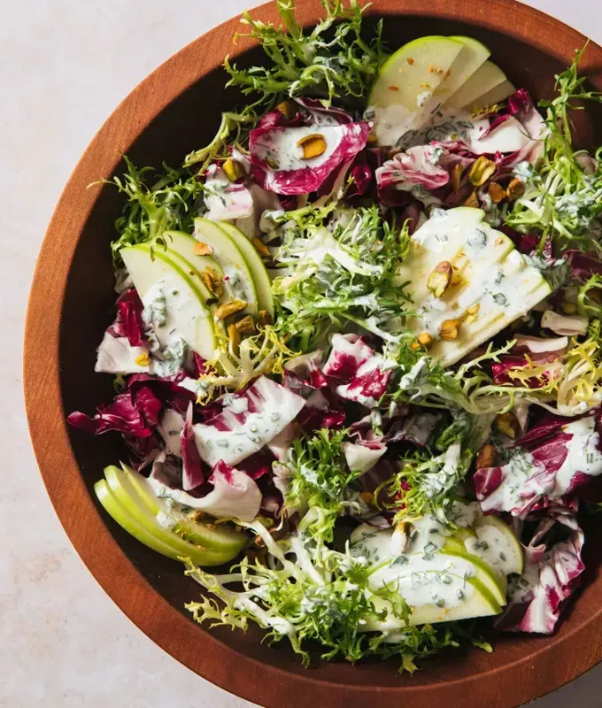 best appetizers to bring to a party: bitter greens salad with herby ranch dressing' title='The 25 Best Appetizers to Bring to a Party from Crowd-Pleasing Dips to Make-Ahead Snacks