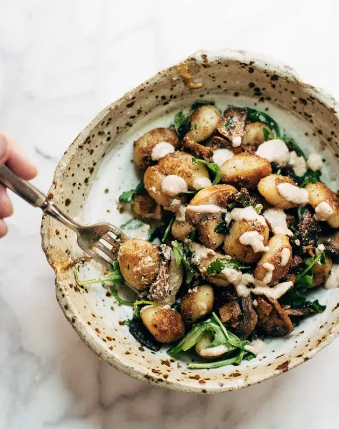easy gnocchi recipes: mushroom gnocchi with arugula and walnut pesto' title='35 Easy Gnocchi Recipes You Can Make at Home